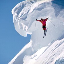 Лыжник в горах в прыжке на аву