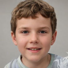 Photo of a cheerful boy on a gray background