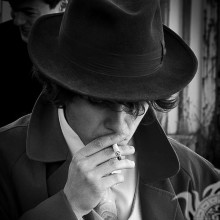 A man in a hat and with a cigarette