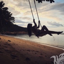 Silhouette of a girl on a swing