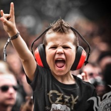 Cool icon kid in headphones at a concert