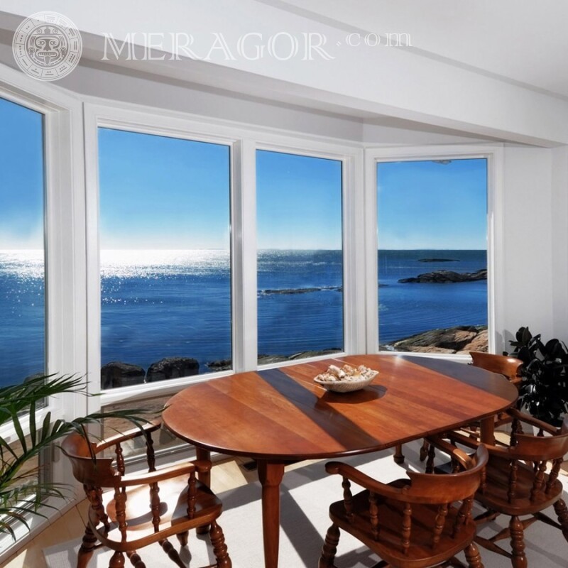 Habitación con una ventana panorámica al mar en tu foto de perfil Edificios