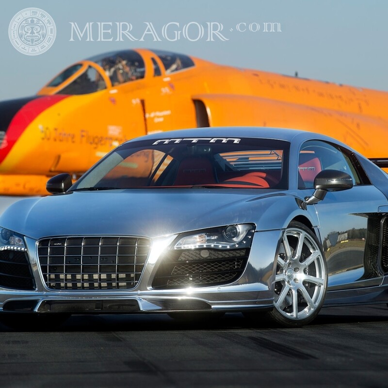 Silver car on the background of an orange jet plane Cars Transport
