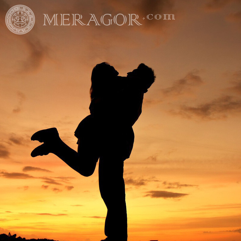 Hugs on the background of sunset for profile Silhouette Boy with girl
