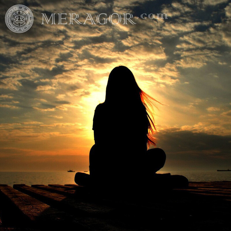 Girl in yoga pose on the pier for account Silhouette