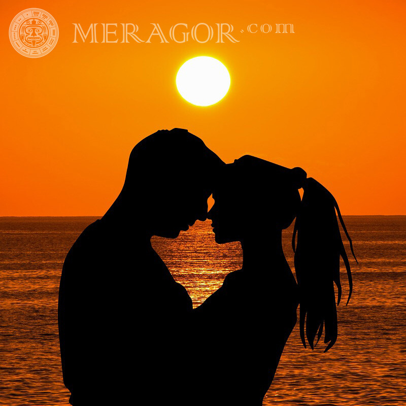 Couple on the background of the sea and the sun Silhouette Love Boy with girl